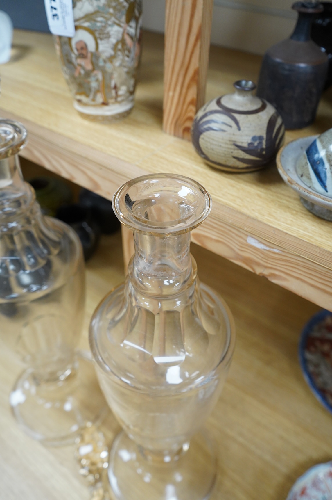 A pair of Victorian clear glass chemist display bottles and stoppers, 63cm high